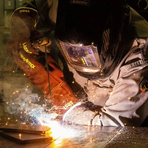 Welder using Welding Heat Resistant Safety Gloves With HeatHide Leather Model 5051 during a project, sparks visible