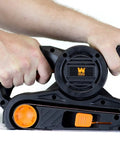 Hands operating Go-To Corded Belt Sander With Dust Bag, 7 Amp Motor, 3 Inch By 21 Inch Belt, Lightweight Six Pound Body