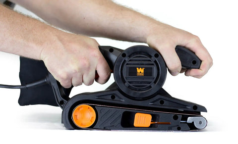 Hands operating Go-To Corded Belt Sander With Dust Bag, 7 Amp Motor, 3 Inch By 21 Inch Belt, Lightweight Six Pound Body