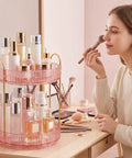 Total Game Changer, 360 Rotation Makeup Organizer For Vanity Desk holding beauty products on a pink two-tier tray.