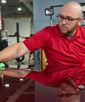 Mens Midweight Short Sleeve Polo Shirt With Snag Resistant Chest Pocket Moisture Wicking Polyester Work Gear worn by a man cleaning a car.