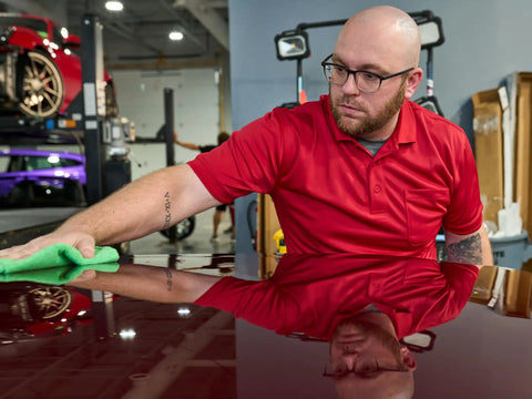 Mens Midweight Short Sleeve Polo Shirt With Snag Resistant Chest Pocket Moisture Wicking Polyester Work Gear worn by a man cleaning a car.