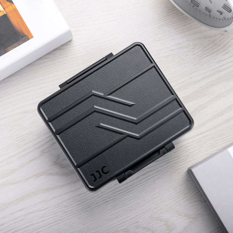Heavy Duty Storage Box For Forty Four Aaa Batteries With Detachable Tester, black ABS case, top view on a light wooden surface.