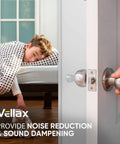 Boy asleep in a bed with polka dot blanket, focusing on door handle showing door bumpers for sound dampening.