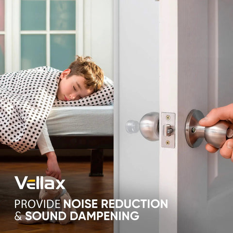 Boy asleep in a bed with polka dot blanket, focusing on door handle showing door bumpers for sound dampening.