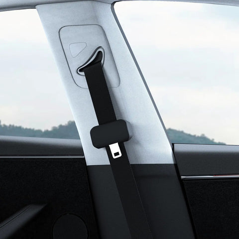 Close-up of Five Pack Silicone Seat Belt Buckle Covers installed in car, black silicone protects interior, universal fit