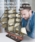 Man admiring completed USS Constitution 3D Ship Puzzle For Adults And Teens Realistic Sailing Boat Model Kit 193 Pieces No Scissors