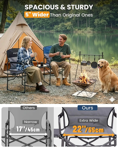 Two people sitting on an Oversized Camping Directors Chair With Side Table by a lakeside campfire with a dog.
