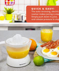 Elite Gourmet Compact Electric Citrus Juicer In White 30 Watt With 16 Oz Capacity for easy citrus juicing on kitchen countertop.