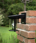Coach Lantern Solar Outdoor Wall Light Fixture Sconce Black With Dusk To Dawn Lighting mounted on brick wall.