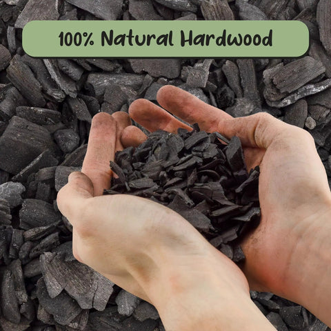 Hands holding hardwood charcoal soil additive for indoor plants 2 quarts, perfect for orchids, terrariums, and gardens.