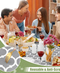 Grey Elastic Flannel Backed Vinyl Table Cover For 6 Foot Tables Waterproof Wipeable Indoor Outdoor Rectangle Picnic Tablecloth Windproof Fit For No Fuss Everyday Use 30x72 Inches with people dining.