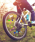 Rider on bike with 180 Pieces Colorful Bike Wheel Spoke Beads Clips For Kids Bicycle Spoke Decorations, bright assorted colors.