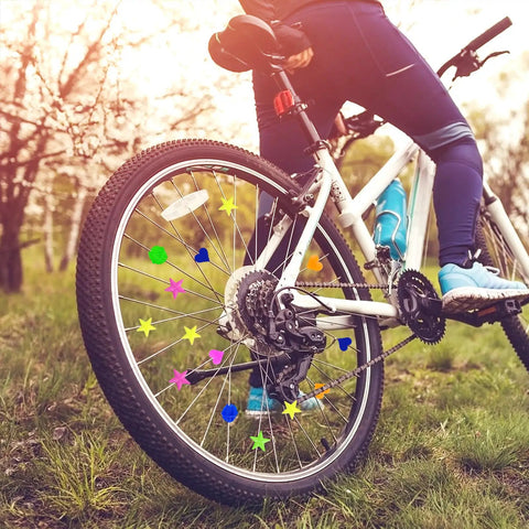 Rider on bike with 180 Pieces Colorful Bike Wheel Spoke Beads Clips For Kids Bicycle Spoke Decorations, bright assorted colors.
