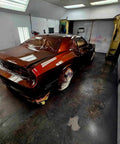 Molten Merlot Professional Car Paint Basecoat Full Gallon Volume Ready To Spray Straight Out The Can With Premium Slow Reducer For Slick Coverage And A Badass Garage Ready Finish on car in spray booth.