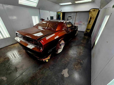 Molten Merlot Professional Car Paint Basecoat Full Gallon Volume Ready To Spray Straight Out The Can With Premium Slow Reducer For Slick Coverage And A Badass Garage Ready Finish on car in spray booth.