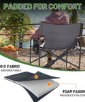 Back view of the Beefy Heavy Duty XXL Director's Chair With Extra Wide 32 Inch Seat And 500 Lb Capacity, outdoors by a lake.
