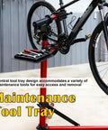 Heavy Duty E Bike Repair Stand With 110 Lbs Capacity featuring central tool tray and bicycle on red maintenance rack.