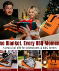 People using the Five Layer Insulated Meat Resting Blanket with Aluminum Foil Lining during a BBQ, featuring side pocket and zippers.