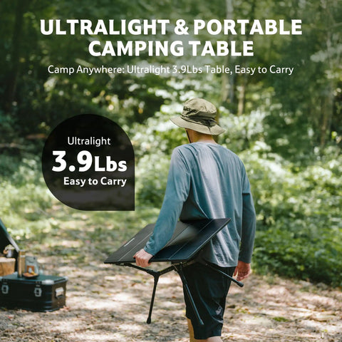 Person carrying YL01 Portable Camping Table No Tools Required Quick Setup Lightweight Aluminum Folding Table in forest