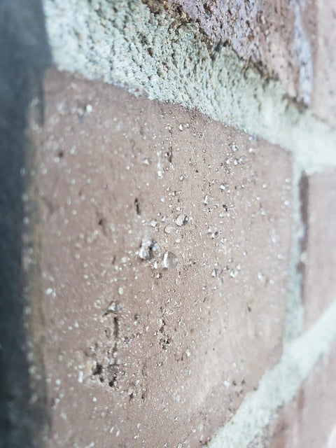 Close-up of brick with Ultimate Sealant Invisible Water Repellent Coating for Concrete and Masonry Porous Surfaces SiO2 Nano Based