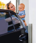 Two Pack High Density Rubber Corner Guards Edge Protectors on a garage wall, woman holding baby near parked car, neutral grey color
