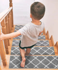 Child walking down steps with 15 Piece Non Slip Stair Treads For Wooden Steps Indoor Carpet Runner Rugs Mat 8x30 Inches Gray Diamond Pattern Soft Grip Easy Install Durable Polyester