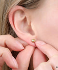 14K Solid Gold Ball Stud Earrings Three Pair Pack With 3mm 4mm And 5mm Sizes Yellow Color Finish And Butterfly Backings Great For Sensitive Ears Everyday Wear And Sparkle. 3mm gold ball stud on ear