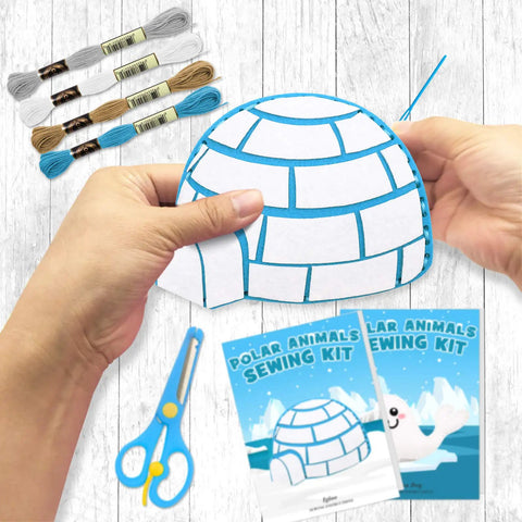 Hands using Polar Animals Sewing Kit For Kids Make Your Own Winter Felt Plush Toys with 14 Creative Projects, showing igloo project.