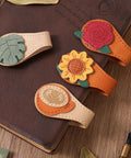 4 Piece Vintage Magnetic Leather Bookmarks With Retro PU Clip, featuring colorful floral designs on a brown leather notebook.