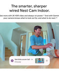 Person setting up Nest Cam Indoor Wired 3rd Gen Security Camera with crisp 2K HDR video and Gemini AI, near staircase, Snow finish.