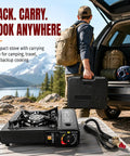 Man carrying Dual Fuel Camping Stove Run On Butane Or Propane, Portable Outdoor Cooking Gear with Case near car in mountain setting.
