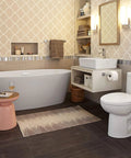Bathroom interior with Times Square Single Handle Monoblock Faucet In Polished Chrome, modern tub, toilet, and decorative wall tiles.