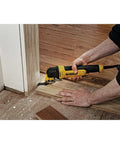 Person using Oscillating Multi Tool Kit With 3 Amp Motor Dual Grip Variable Speed Trigger Quick Change System Universal Accessory