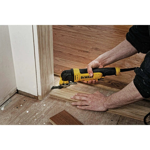 Person using Oscillating Multi Tool Kit With 3 Amp Motor Dual Grip Variable Speed Trigger Quick Change System Universal Accessory