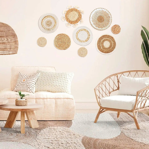 Nine Piece Boho Wall Basket Set Made From Seagrass And Rattan Round Handmade Hanging Baskets For Farmhouse Living Room Bedroom Display Kitchen And Home Decor Eco Friendly Natural Wicker Vibe displayed on beige wall in living room with wicker chair and sofa.