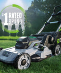 Cordless Electric Lawn Mower With 56V 6.0Ah Battery And 320W Charger on grass, showcasing brushless motor and 21-inch deck