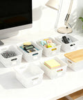 Six Pack Stackable Plastic Storage Bins With Lids And Bamboo Lid, arranged on a desk, showcasing organization use.