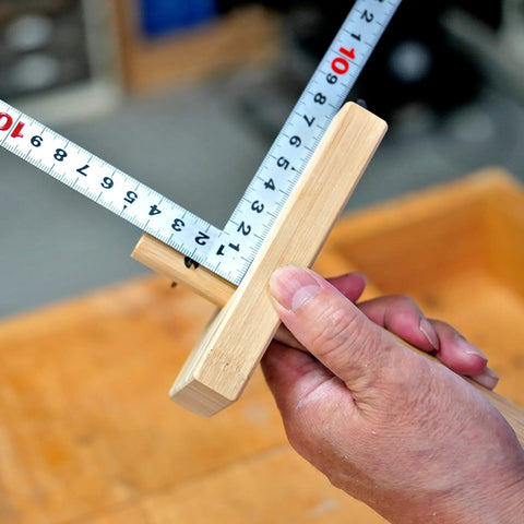 Close-up of Woodworking Marking Gauge 4.75 Inch 120mm Adjustable Kebiki Japanese Scribe, bamboo body, in use with metric scale.
