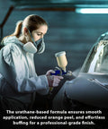 Side view of technician applying Restoration Shop 2K urethane clear coat on car with spray gun