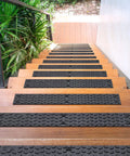 Non Slip Outdoor Stair Treads 4x24 Inch Diamond Textured Rubber Mats for Steps on wooden staircase, lush greenery side view.