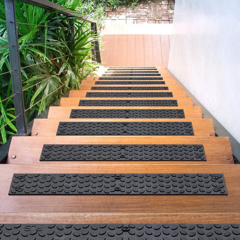 Non Slip Outdoor Stair Treads 4x24 Inch Diamond Textured Rubber Mats for Steps on wooden staircase, lush greenery side view.