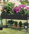 Elevated Garden Bed With Legs And Storage Shelf, Mobile Planter Box For Outdoor Plants, Heavy Duty Metal Raised Garden Bed For Backyard Or Balcony, Anti Rust Coating, Black, 51 By 26 By 31.5 Inches with flowers and pots on grass