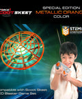 Scoot Skeet Mini Drone Shooting Game For Kids Drone Only Hand Drones Compatible With Scoot Skeet LED Blaster Indoor Target Game Orange Rechargeable Battery USB Charger Included Indoor Fun Family Friendly Tech Toy with boy aiming blaster.