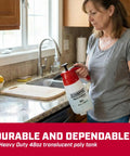 Person holding 48oz Handheld Pump Sprayer for Lawn and Garden with Wide Mouth Translucent Poly Tank at kitchen sink