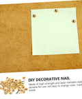 Image of 200Pcs DIY Craft Nails For Wall Hangings And Scrapbooking Kit with white paper tacked to cork board using brass pin fasteners.