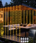 Solar Curtain Lights 7.9 Feet By 6 Feet With 144 LEDs Outdoor Waterproof Fairy String Lights illuminating patio gazebo with solar panel