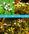 8 Pack 64 LED Solar Firefly Garden Lights Waterproof Outdoor Swaying Fairy Lights in a garden setting, lit at night.