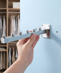 Hand installing Slatwall Waterfall Hooks Set With 6 Beads Heavy Duty Aluminum Garment Hanger Rack 11.8 Inch on wall