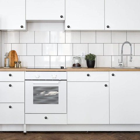 Modern kitchen with 60 Pack Matte Black Kitchen Cabinet Knobs One And A Quarter Inch Round Drawer Pulls on white cabinets.